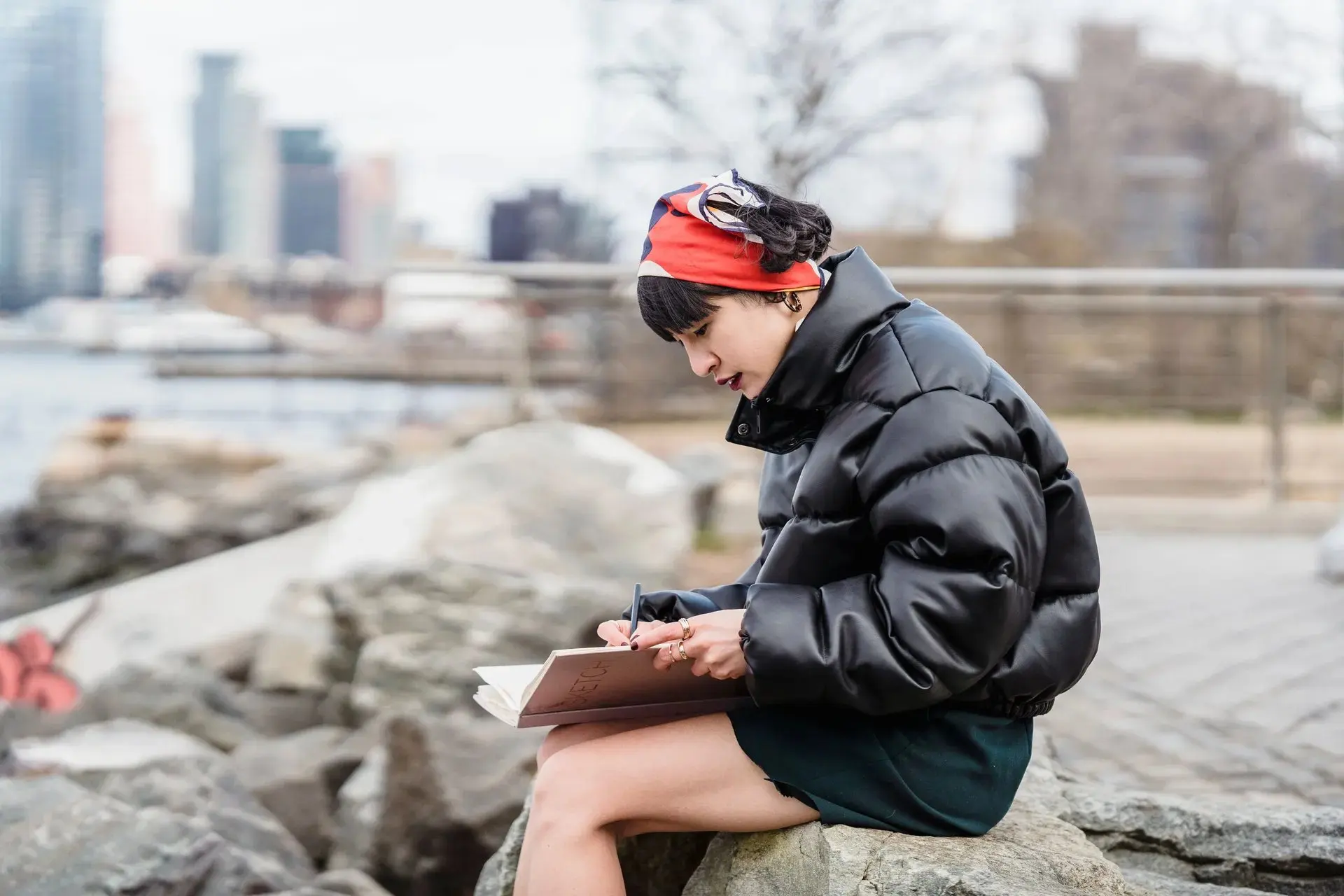 Traveller reading a guidebook at a river